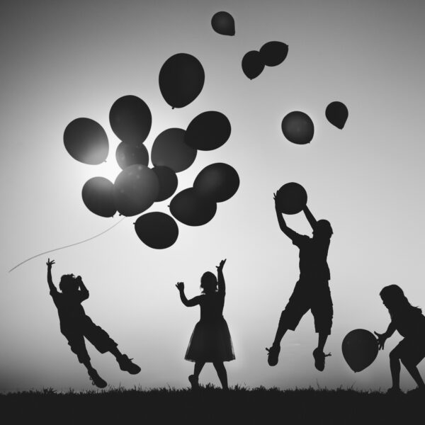 Children Outdoors Playing with Balloons